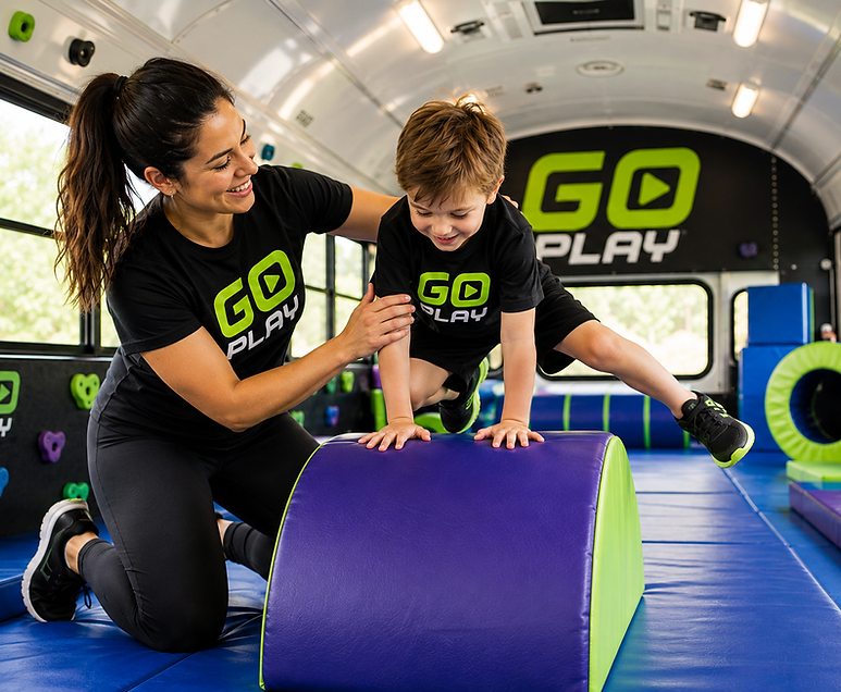 A Go Play coach helping a child through an activity